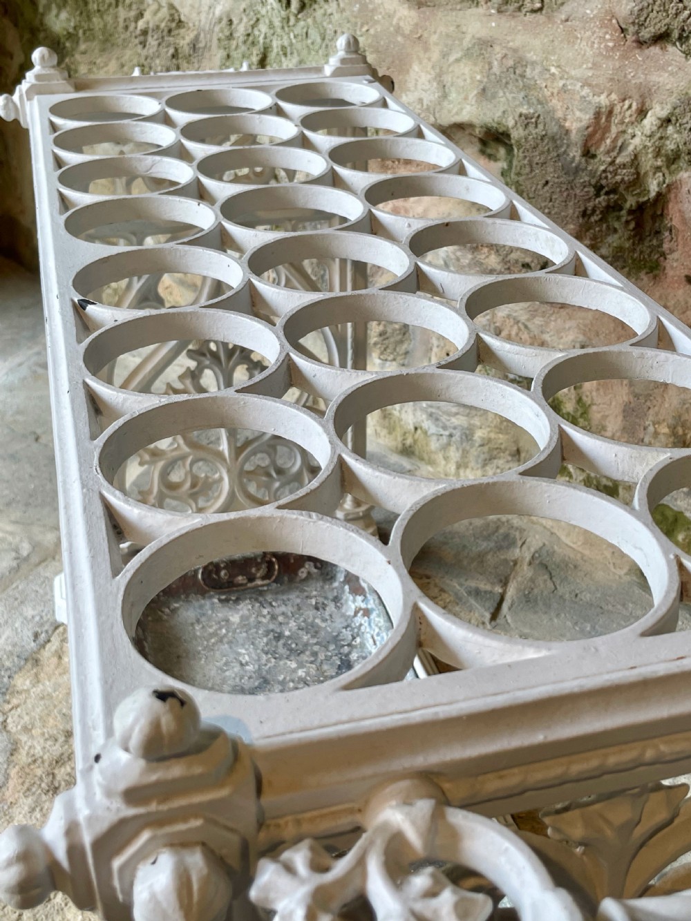 A white painted cast iron stick stand featuring openwork Gothic tracery side panels, a circular grid top section, and a removable double drip tray. View XVIII