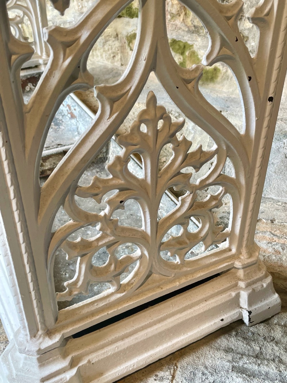 A white painted cast iron stick stand featuring openwork Gothic tracery side panels, a circular grid top section, and a removable double drip tray. View XX