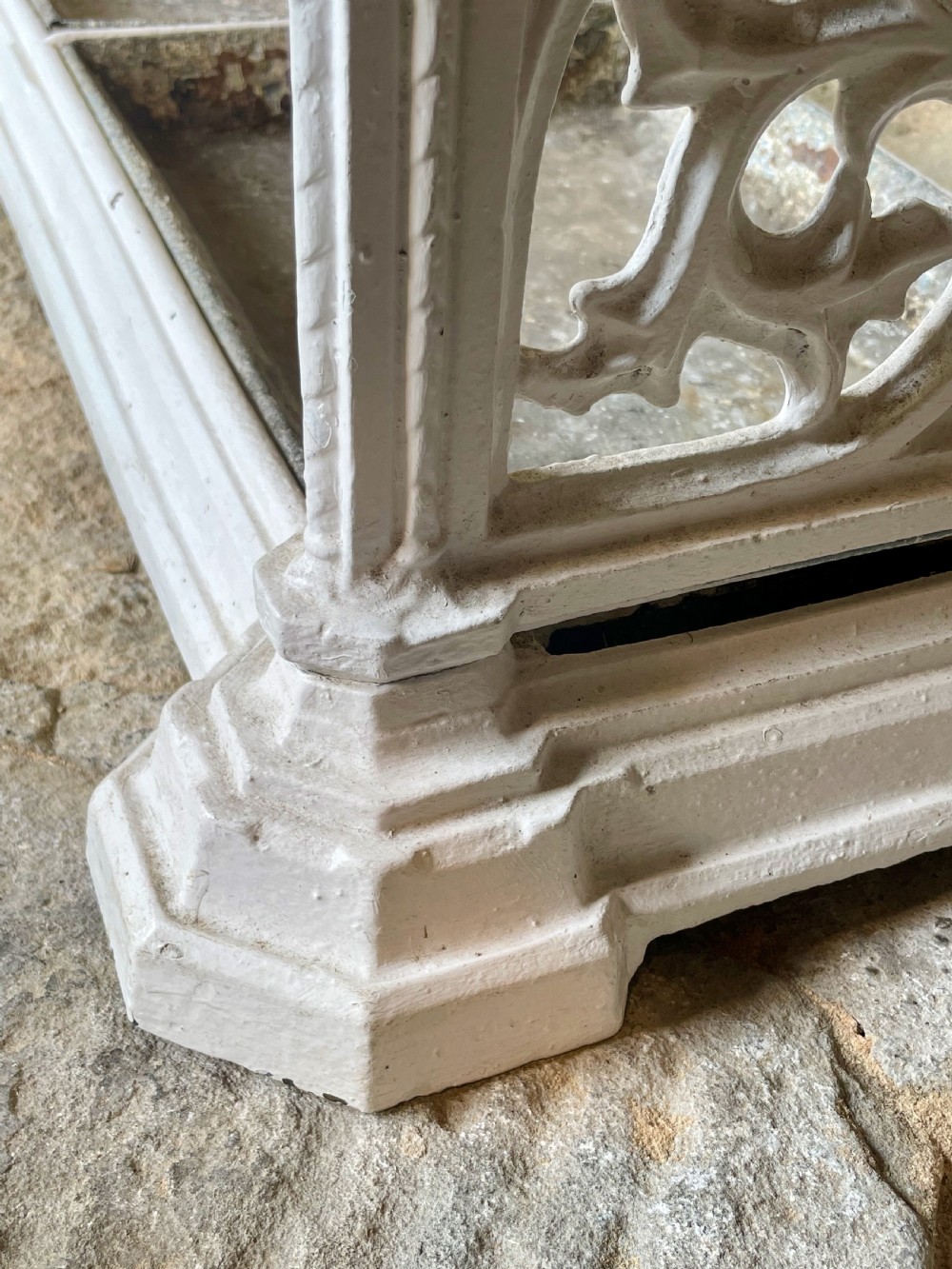 A white painted cast iron stick stand featuring openwork Gothic tracery side panels, a circular grid top section, and a removable double drip tray. View XXI