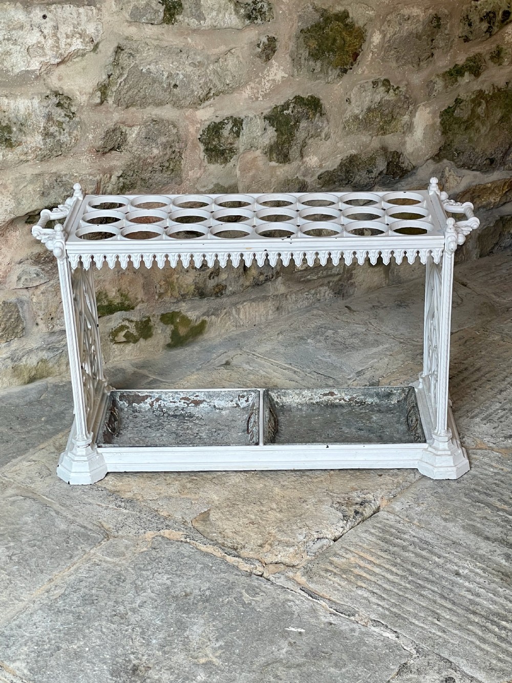 A white painted cast iron stick stand featuring openwork Gothic tracery side panels, a circular grid top section, and a removable double drip tray. View XXIV