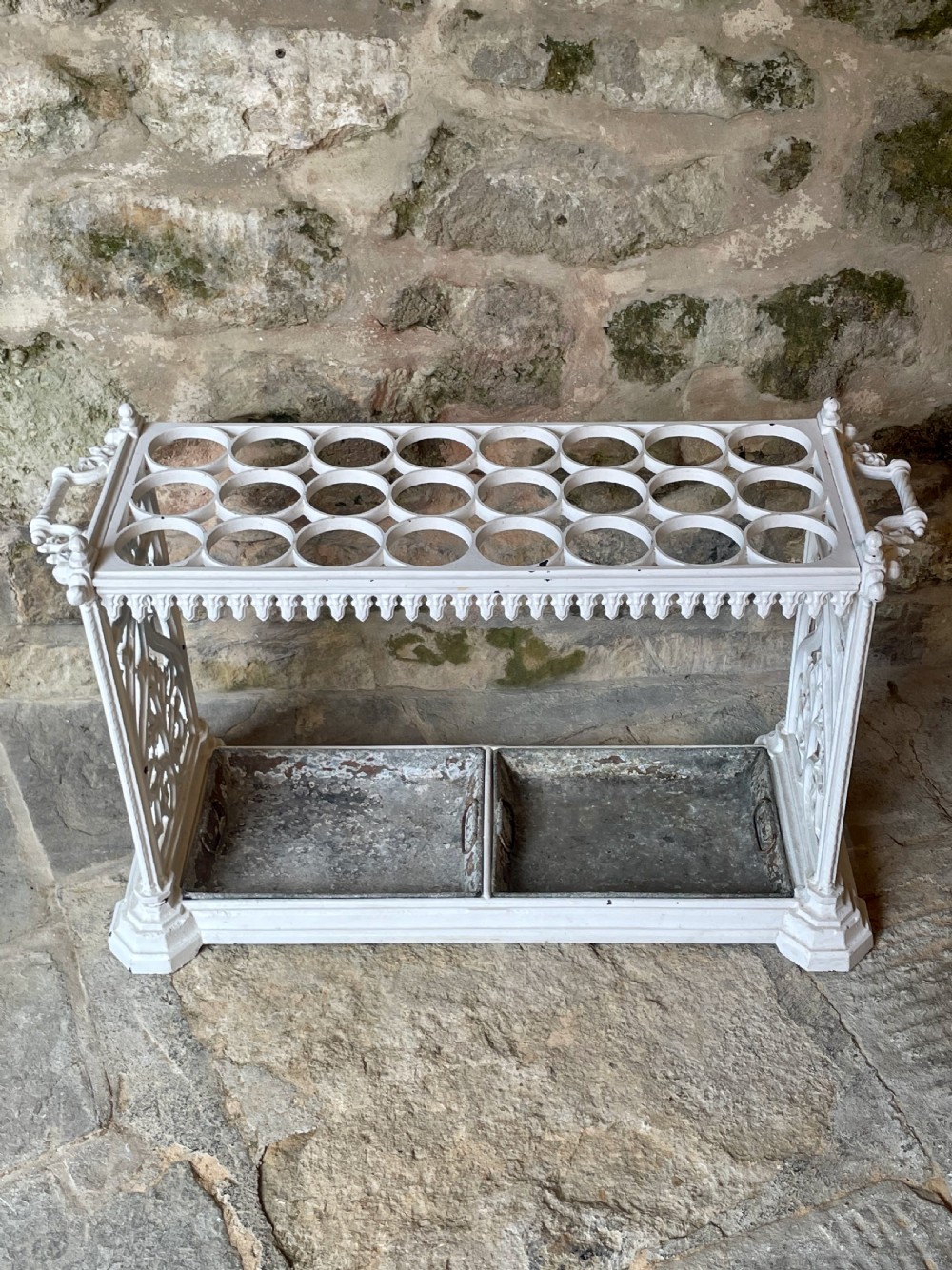 A white painted cast iron stick stand featuring openwork Gothic tracery side panels, a circular grid top section, and a removable double drip tray. View XXV