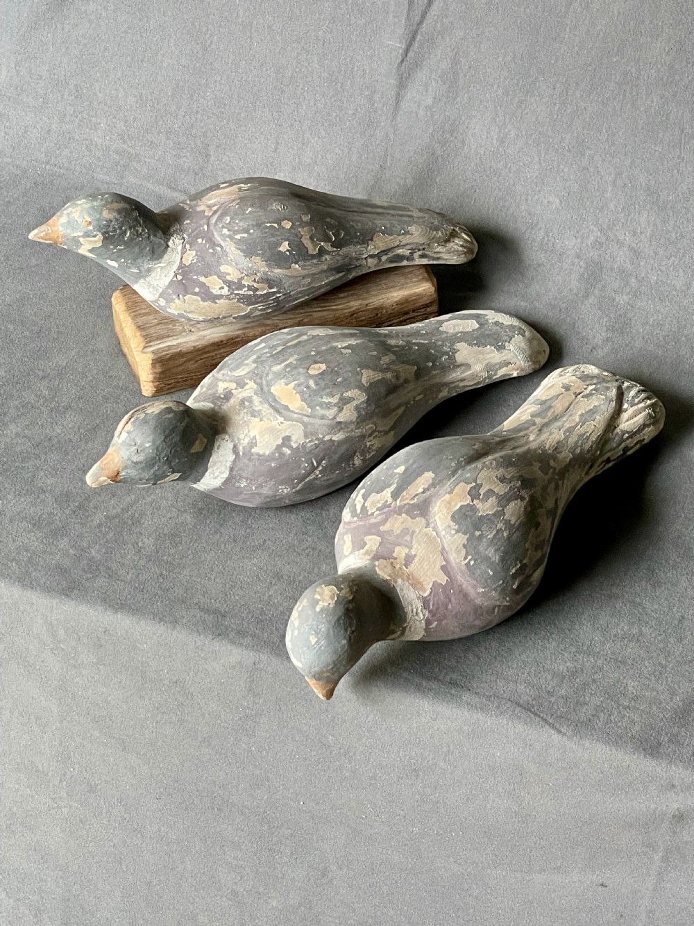 Three decoy pigeon figures