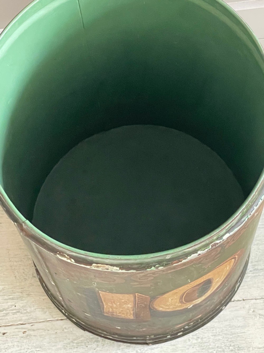A cylindrical green painted antique metal tea canister featuring gold scrollwork and the painted number ten. View V