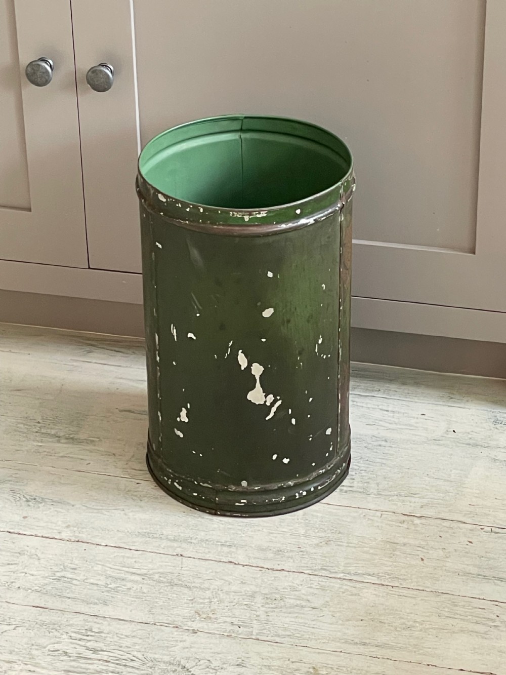 A cylindrical green painted antique metal tea canister featuring gold scrollwork and the painted number ten. View VII