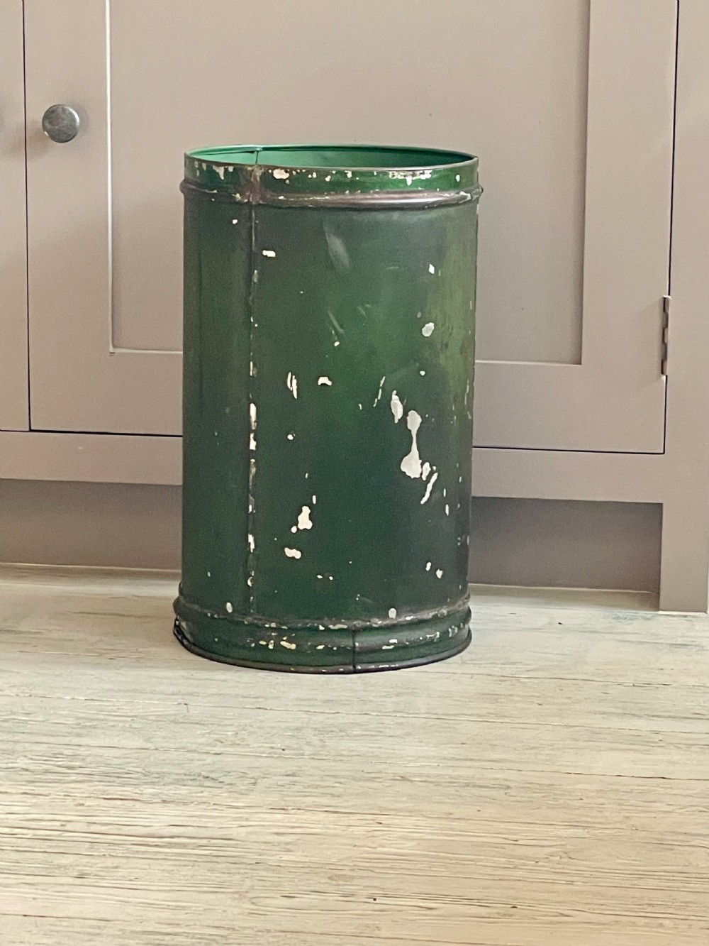 A cylindrical green painted antique metal tea canister featuring gold scrollwork and the painted number ten. View VIII