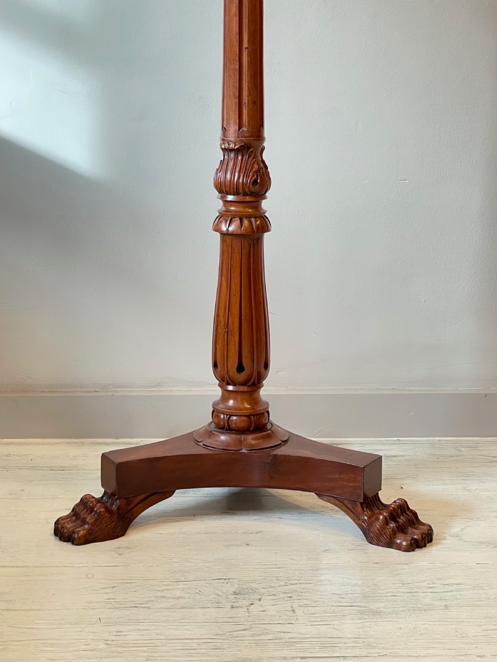 A nineteenth-century mahogany music stand featuring a lyre-shaped rest, a carved turned stem, and a triform base terminating in paw feet. View III