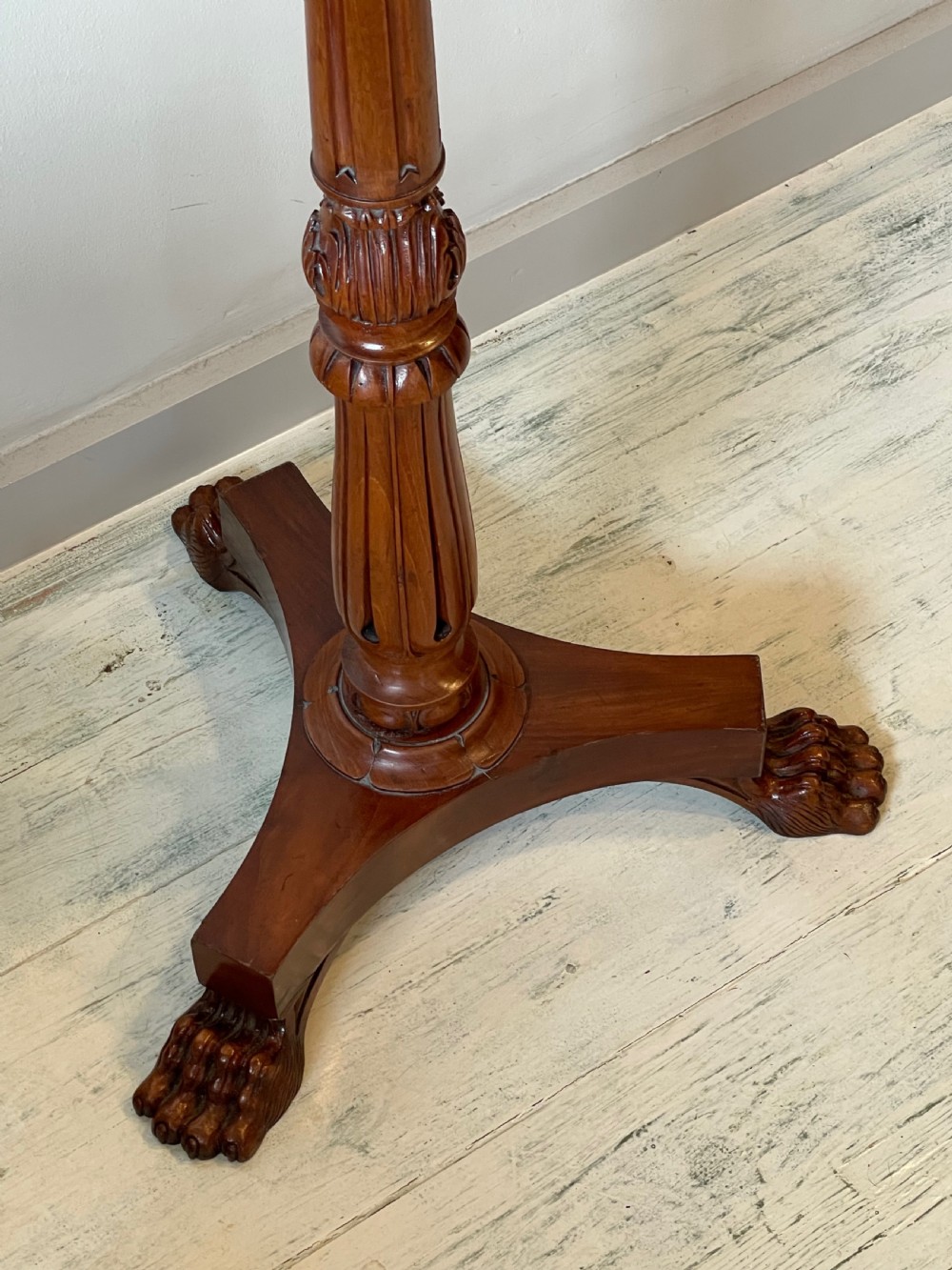 A nineteenth-century mahogany music stand featuring a lyre-shaped rest, a carved turned stem, and a triform base terminating in paw feet. View V
