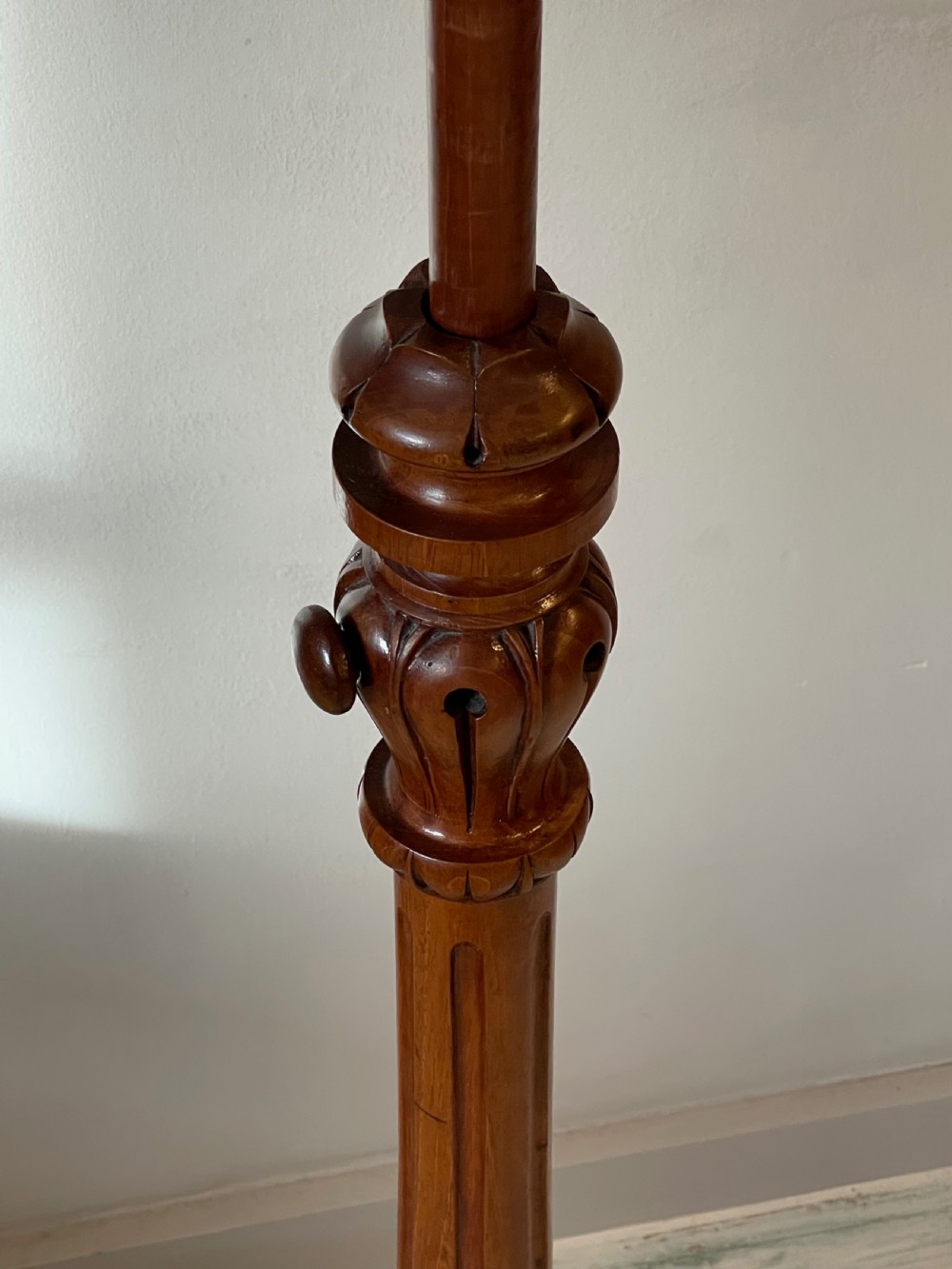 A nineteenth-century mahogany music stand featuring a lyre-shaped rest, a carved turned stem, and a triform base terminating in paw feet. View IX