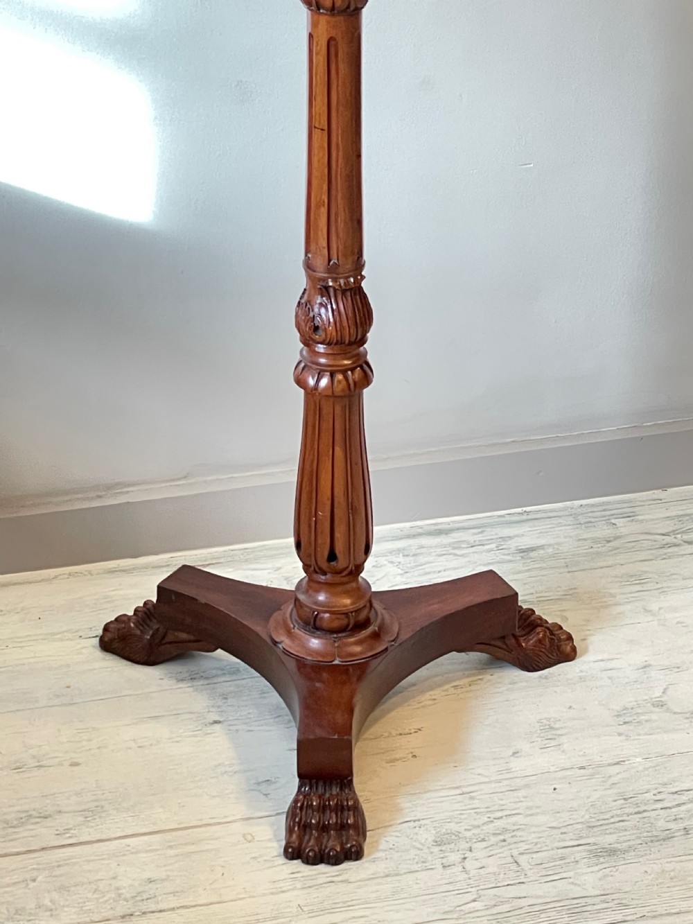 A nineteenth-century mahogany music stand featuring a lyre-shaped rest, a carved turned stem, and a triform base terminating in paw feet. View XIII