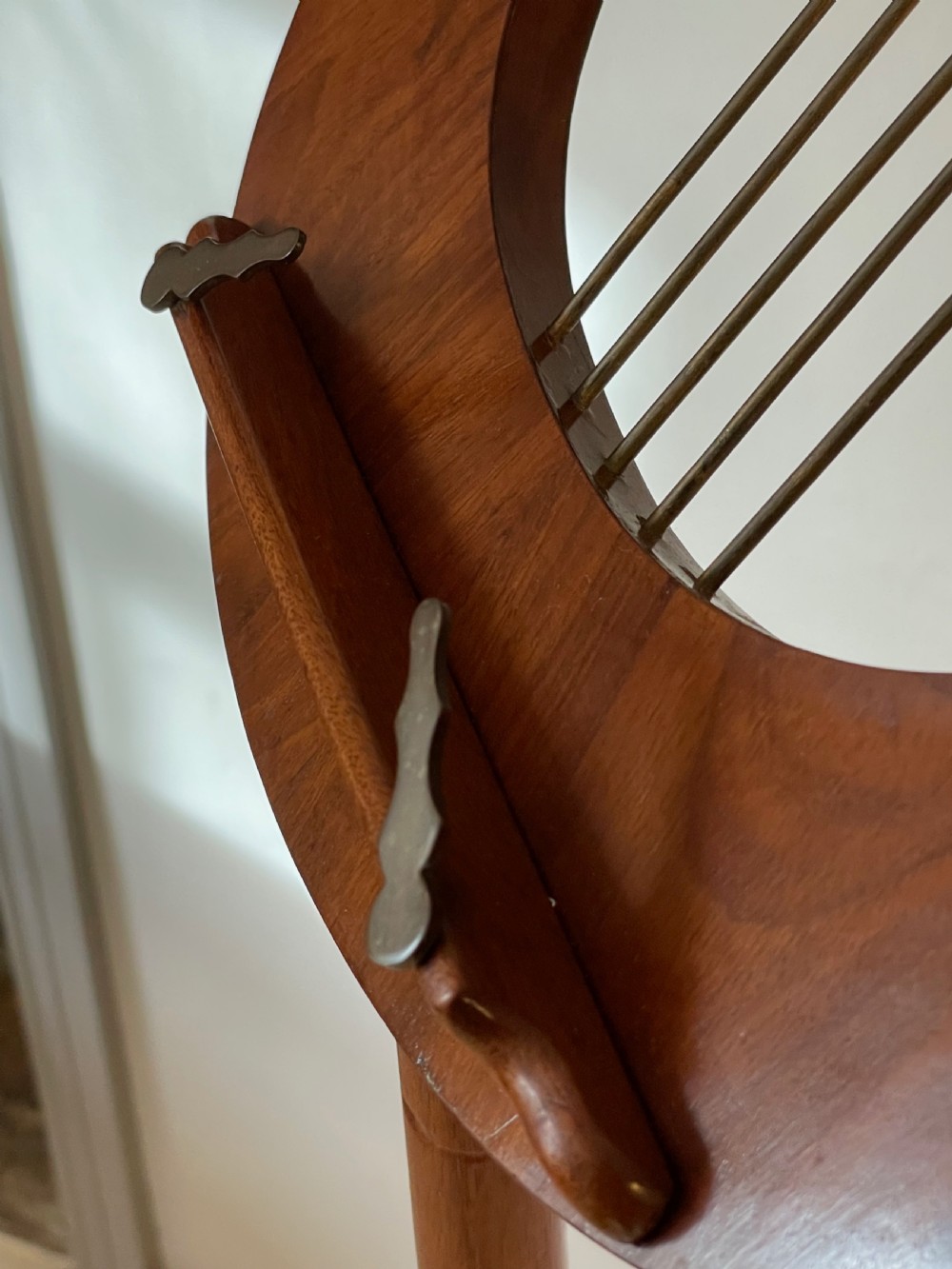 A nineteenth-century mahogany music stand featuring a lyre-shaped rest, a carved turned stem, and a triform base terminating in paw feet. View XV