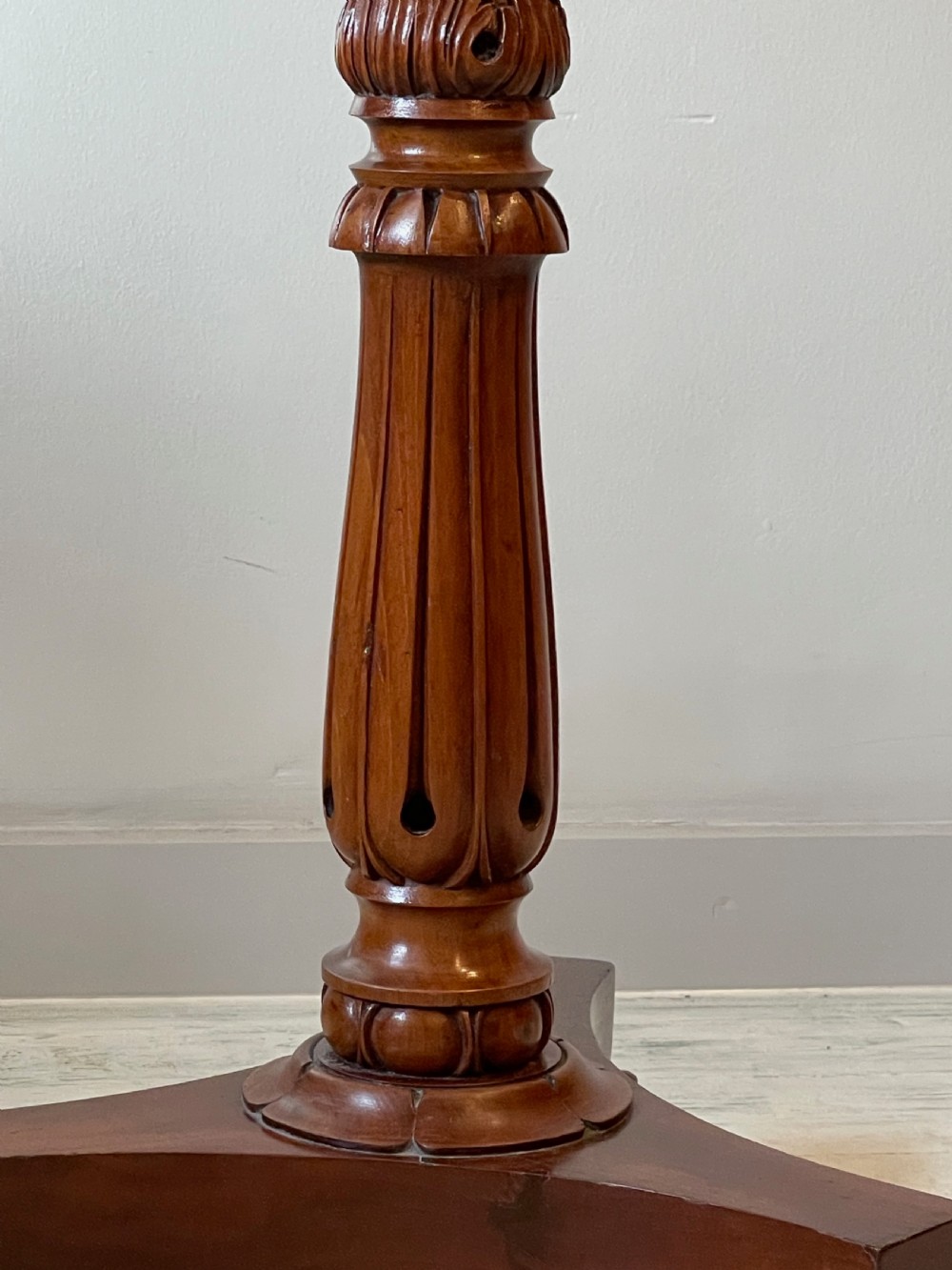 A nineteenth-century mahogany music stand featuring a lyre-shaped rest, a carved turned stem, and a triform base terminating in paw feet. View XVIII