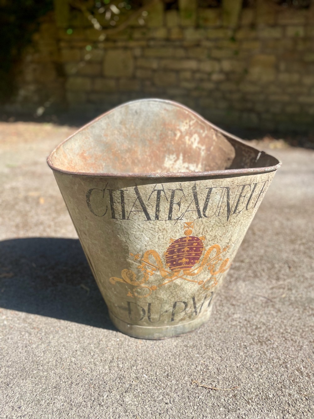 A tapered 19th-century metal grape hod featuring a distressed beige finish with hand-painted Chateauneuf-du-Pape lettering and a papal crest. View II