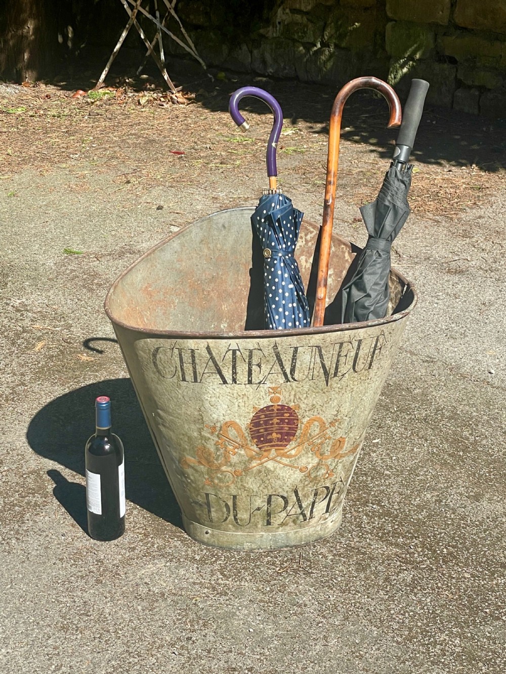 A tapered 19th-century metal grape hod featuring a distressed beige finish with hand-painted Chateauneuf-du-Pape lettering and a papal crest. View XI