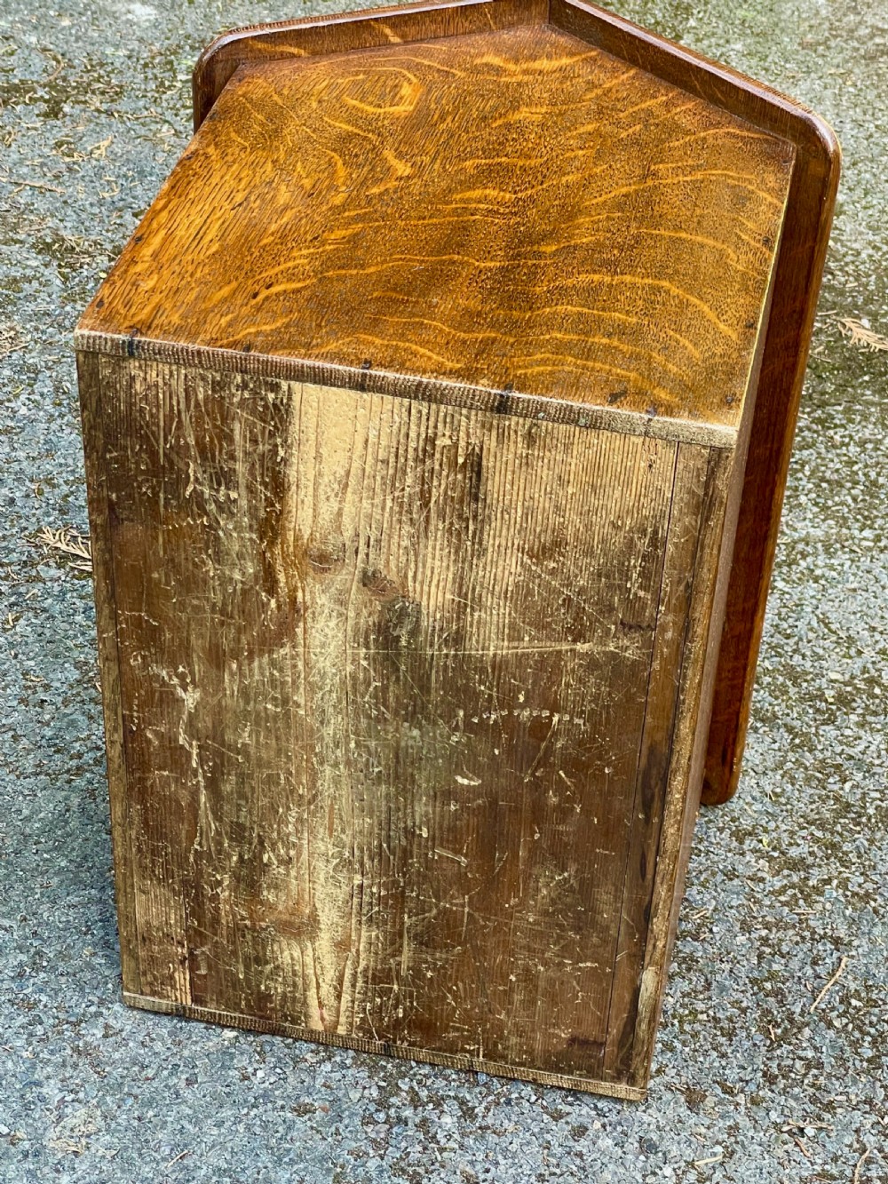 An antique Victorian warm brown oak dog kennel featuring a pitched roof, arched entrance aperture, and trefoil ventilation cutouts along the side. View XIII