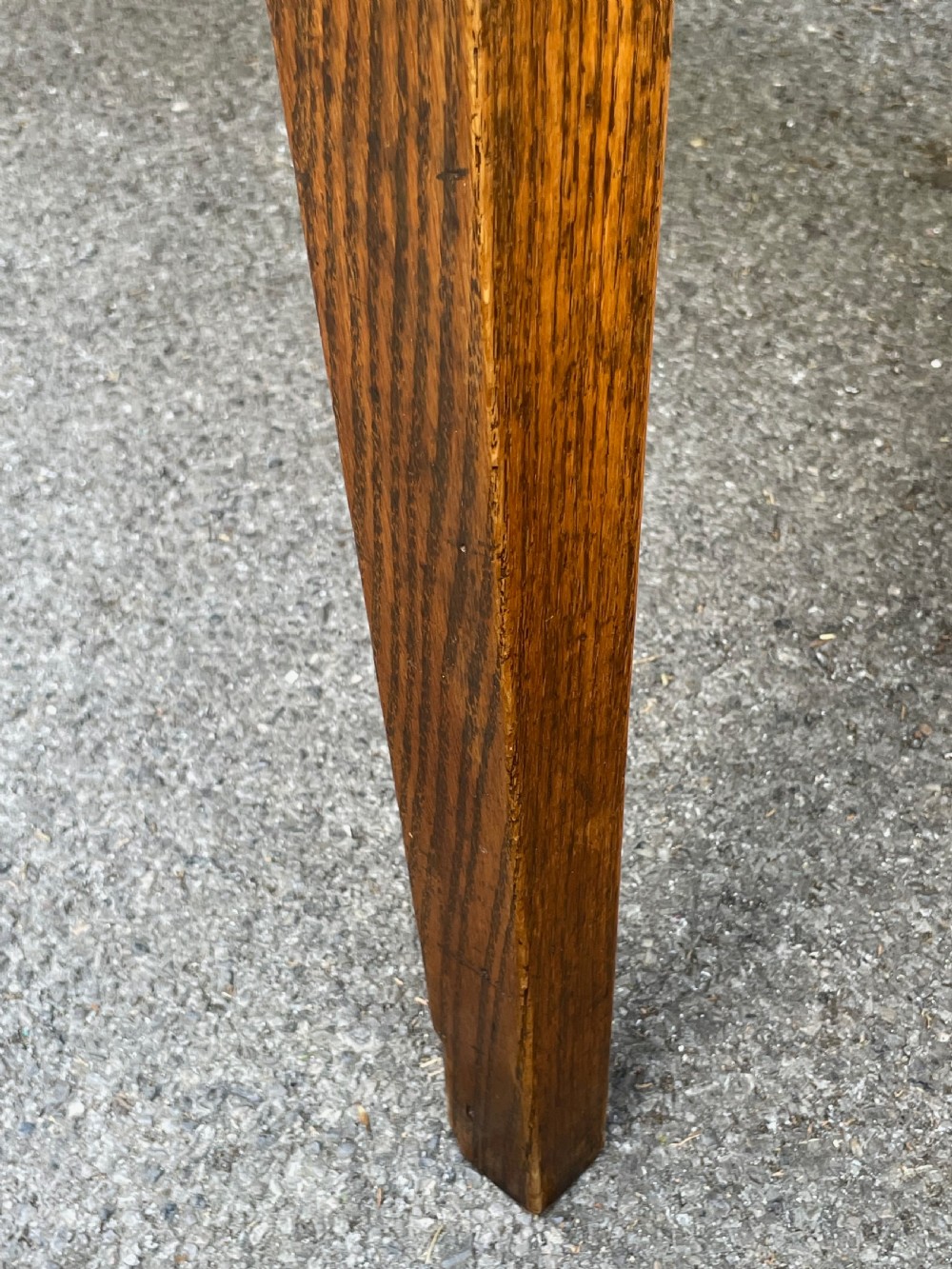 A long wooden refectory dining table constructed with a three-plank top and four square tapered legs. View XIV