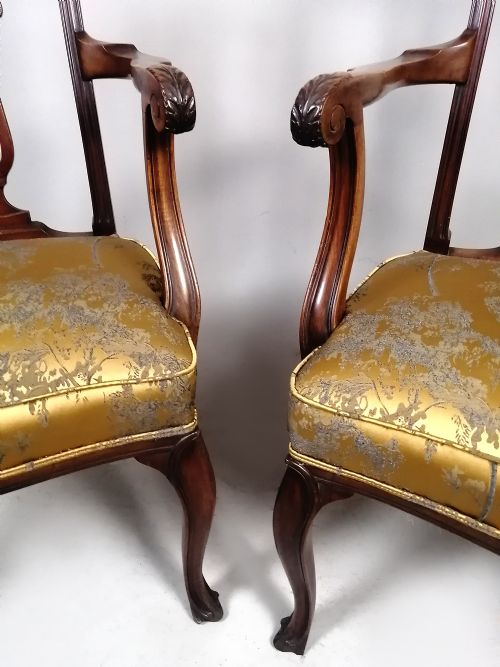fig 1. A pair of late Victorian mahogany elbow chairs featuring carved lyre back splats, curved arms, cabriole legs, and gold patterned upholstered seats.