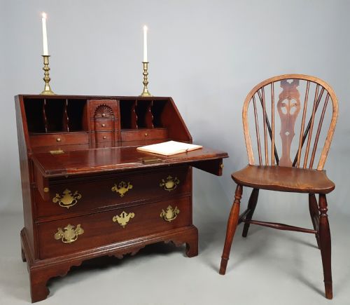 fig 1. An 18th-century George II slant-front writing bureau made of warm brown fruitwood with brass drop handles and bracket feet.