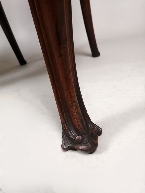 fig 2. A pair of late Victorian mahogany armchairs featuring pierced lyre back splats, curved arms, cabriole front legs, and gold patterned fabric seats.