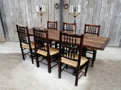 fig 1. An early nineteenth-century solid elm refectory dining table with a thick plank top and a central carved trestle support.