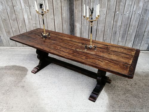 fig 2. An early nineteenth-century solid elm refectory dining table with a thick plank top and a central carved trestle support.