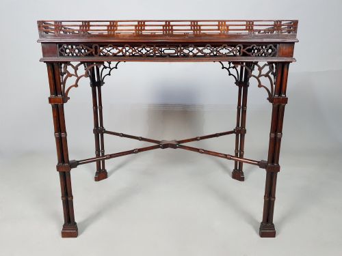 fig 2. A dark padauk Chippendale style silver table featuring a pierced gallery rim, fretwork frieze, cluster legs, and turned stretchers.