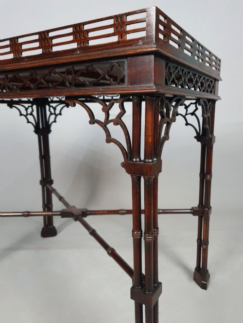 fig 5. A dark padauk Chippendale style silver table featuring a pierced gallery rim, fretwork frieze, cluster legs, and turned stretchers.