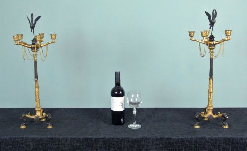 fig 2. A pair of late nineteenth-century French ormolu and patinated bronze multi-light candelabra topped with crane figures and hung with small gilt chains.