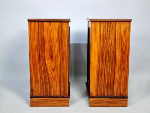 fig 3. A matching pair of late 19th-century rosewood bedside cabinets featuring detailed floral marquetry inlays on the central door panels.