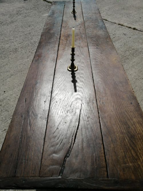 fig 2. A long George I oak and elm refectory table featuring a plank top and low stretcher base.