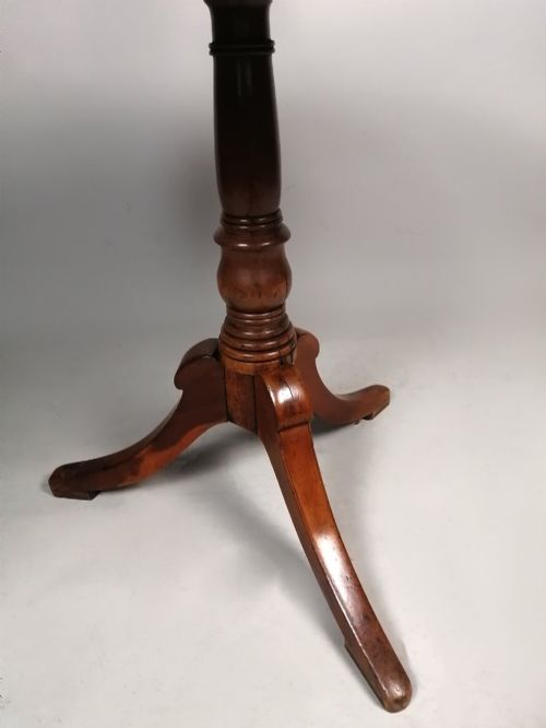 fig 3. A Georgian yew wood circular tilt-top wine table featuring a turned central pedestal and a tripod base.