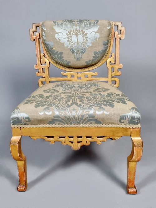 fig 2. A 19th-century Chinese Chippendale style giltwood side chair featuring carved fretwork and damask upholstery.