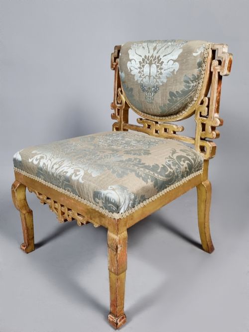 fig 3. A 19th-century Chinese Chippendale style giltwood side chair featuring carved fretwork and damask upholstery.