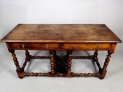 fig 3. A Georgian walnut dresser sideboard featuring two frieze drawers with brass drop handles, turned legs, and low stretchers.