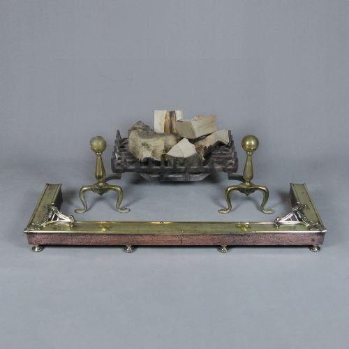 fig 1. An Art Nouveau fire fender made of hammered copper with a polished brass top rail, corner mounts, and small rounded feet.