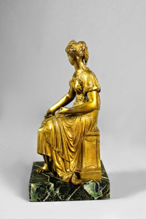 fig 4. A nineteenth-century gilt bronze sculpture depicting the seated Roman goddess Ceres holding a sheaf of wheat on a square green marble base.