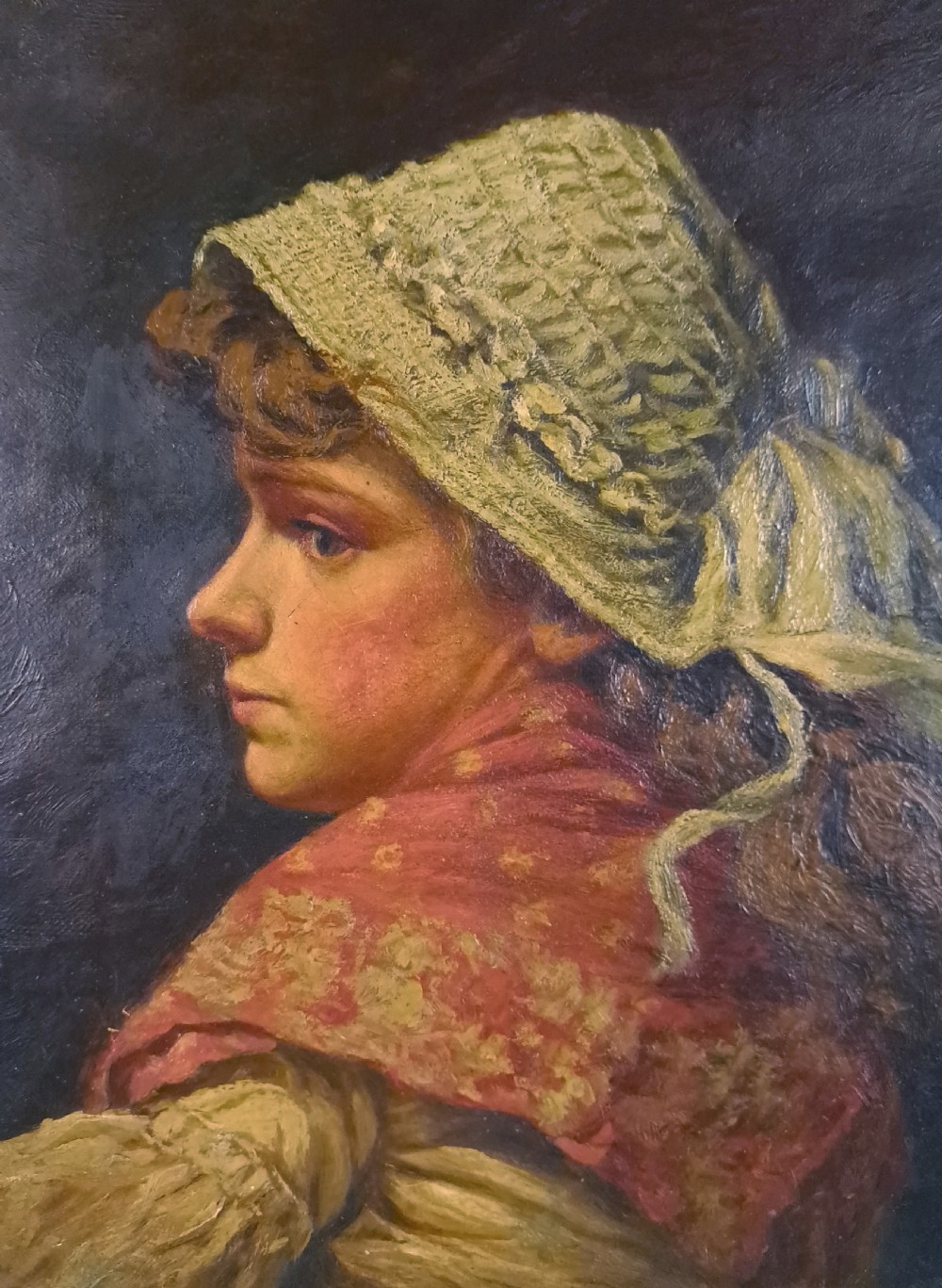 A 19th-century Victorian oil portrait on canvas depicting a young woman in profile wearing a lace bonnet and red shawl, enclosed in an ornate gilded frame. View II
