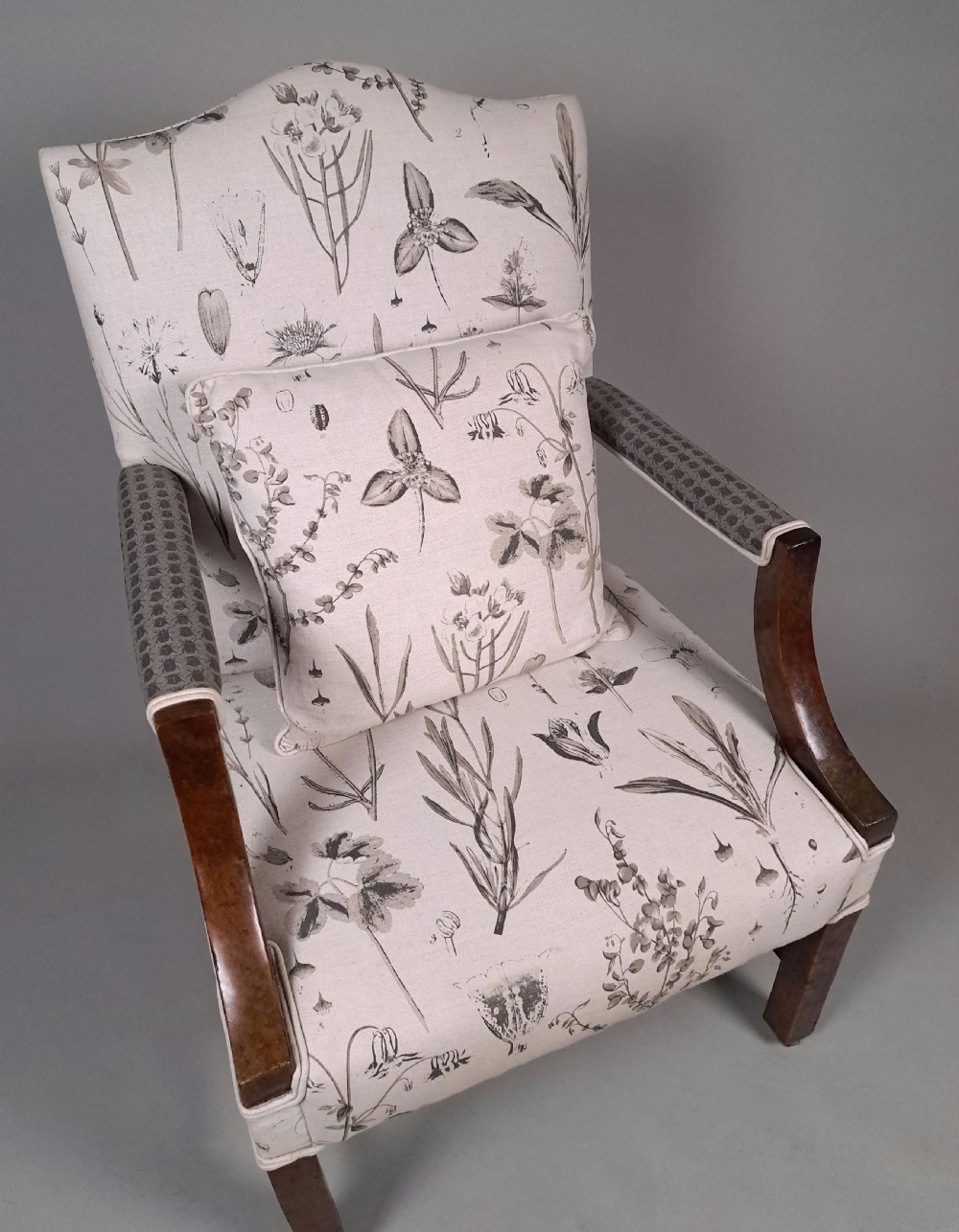 A George III yew wood Gainsborough armchair featuring monochrome botanical fabric upholstery, padded armrests, square legs, and brass castors. View III