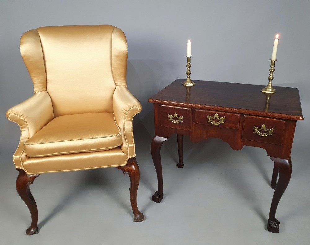 An 18th-century George III red walnut lowboy table with three brass-handled drawers, a shaped apron, and front cabriole legs ending in carved ball-and-claw feet. View III