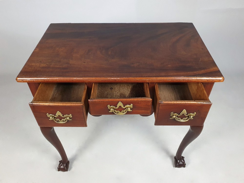 An 18th-century George III red walnut lowboy table with three brass-handled drawers, a shaped apron, and front cabriole legs ending in carved ball-and-claw feet. View VII
