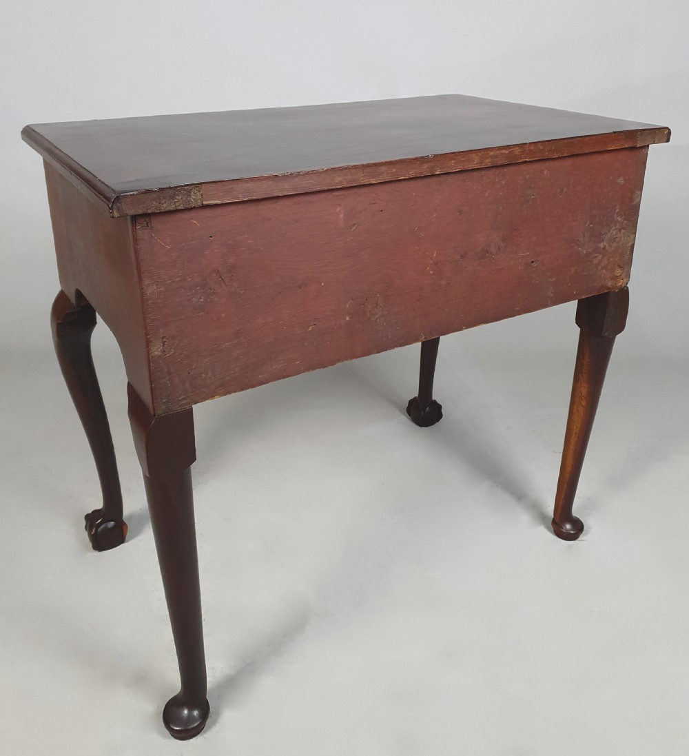 An 18th-century George III red walnut lowboy table with three brass-handled drawers, a shaped apron, and front cabriole legs ending in carved ball-and-claw feet. View IX