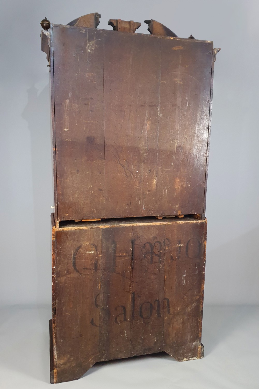 An early 18th-century Queen Anne burr walnut bureau cabinet featuring a double-domed pediment, open doors revealing multiple pigeonholes, a sloped drop-front writing desk, and lower storage drawers. View IX