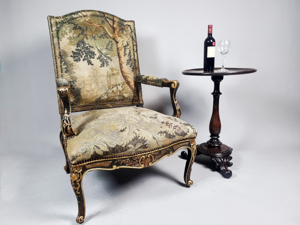 A George III Gainsborough armchair with carved cabriole legs, parcel gilding, and green landscape tapestry upholstery trimmed with brass studs. View II