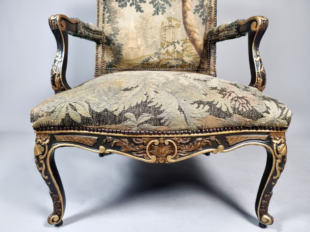 A George III Gainsborough armchair with carved cabriole legs, parcel gilding, and green landscape tapestry upholstery trimmed with brass studs. View VI