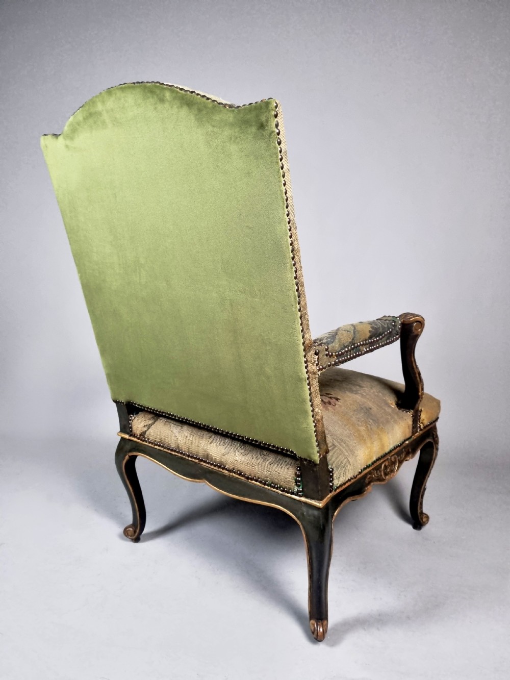 A George III Gainsborough armchair with carved cabriole legs, parcel gilding, and green landscape tapestry upholstery trimmed with brass studs. View VIII