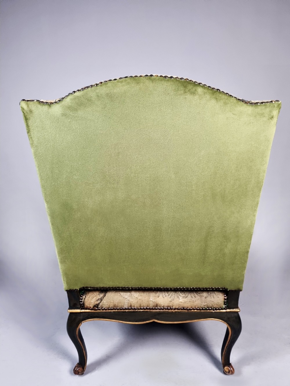 A George III Gainsborough armchair with carved cabriole legs, parcel gilding, and green landscape tapestry upholstery trimmed with brass studs. View IX