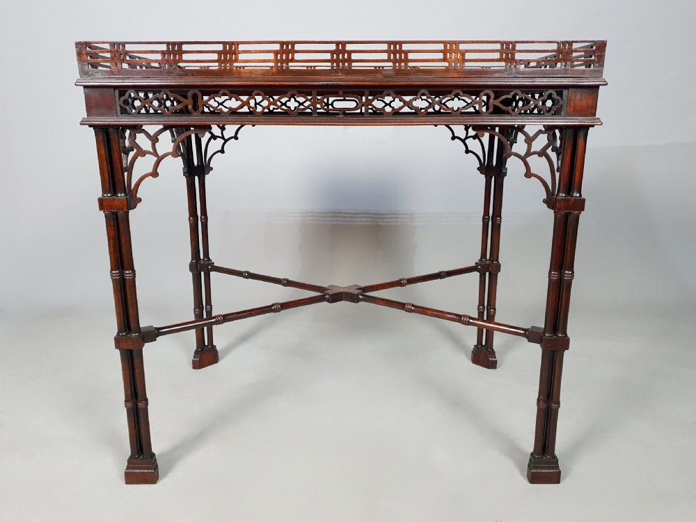 A dark padauk wood silver table featuring a rectangular top surrounded by a lattice gallery rim, supported by pierced Gothic arches and cluster column legs. View III