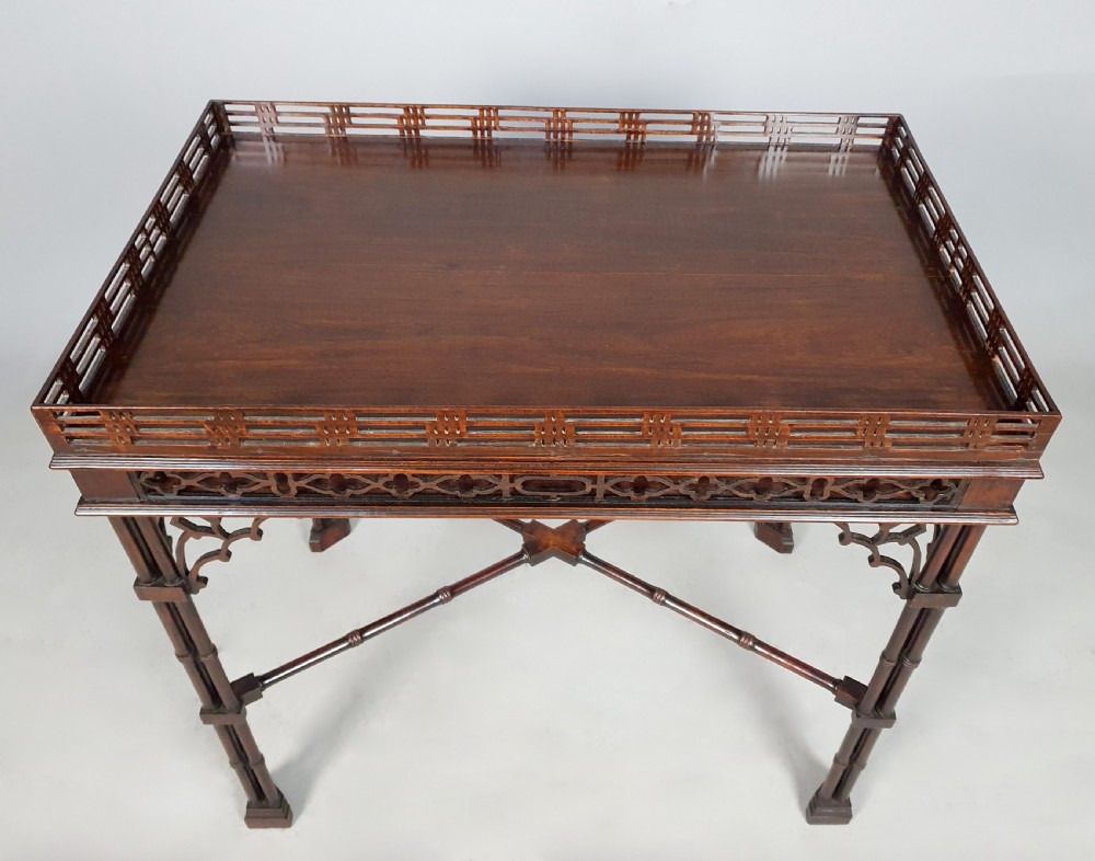 A dark padauk wood silver table featuring a rectangular top surrounded by a lattice gallery rim, supported by pierced Gothic arches and cluster column legs. View V