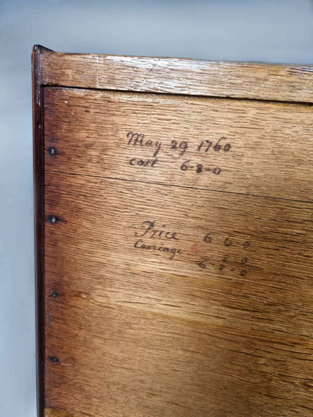 A tall George III mahogany chest on chest featuring stacked drawer sections, pierced brass handles, carved fretwork at the frieze, and bracket feet. View IX