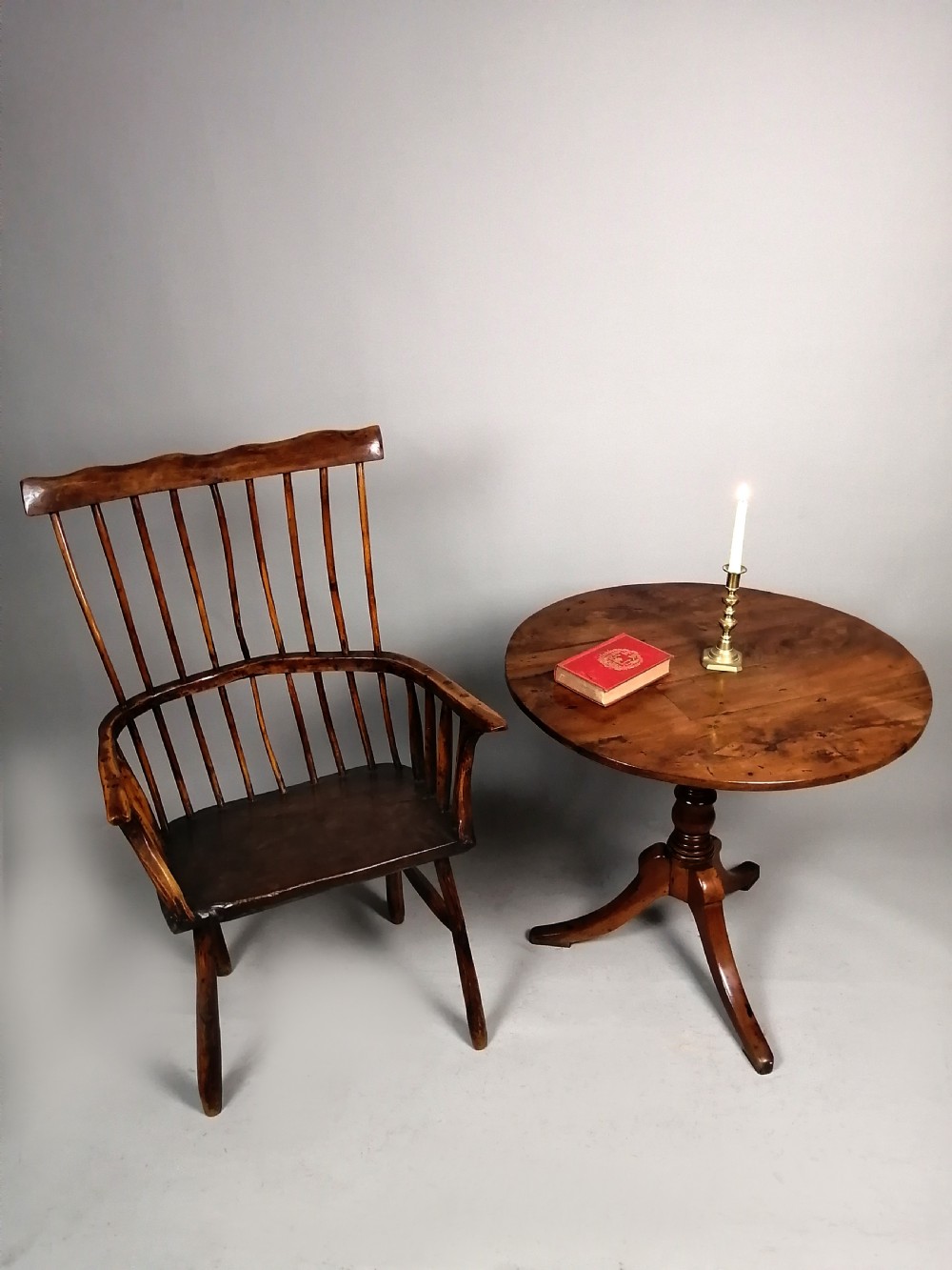 A Georgian yew wood wine table featuring a circular tilt top displaying natural grain patterns, set on a turned central pedestal with three splayed legs. View II