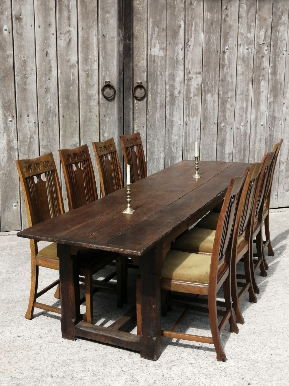 An early eighteenth-century long oak and elm refectory table top showing four wide wooden planks with natural grain, splits, and deep dark patination. View III